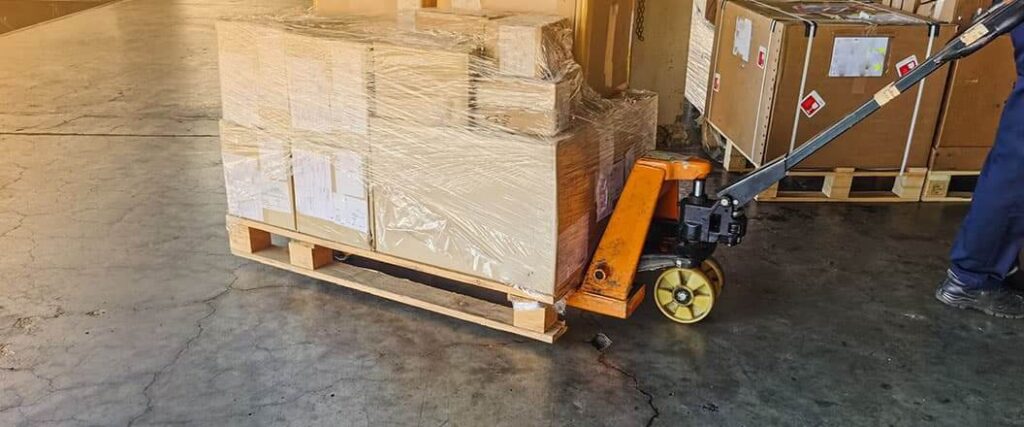 A pallet on pallet jack that's about to be loaded into a delivery vehicle