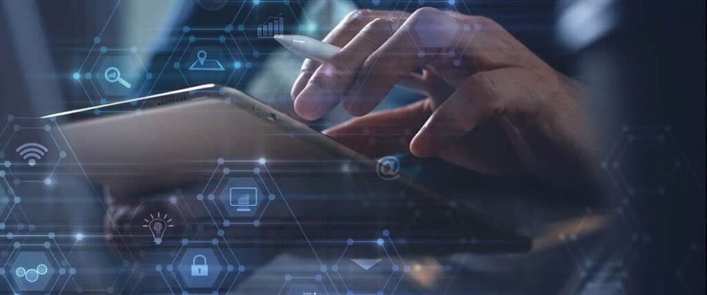 A close up view of a man inputting information on a tablet device.