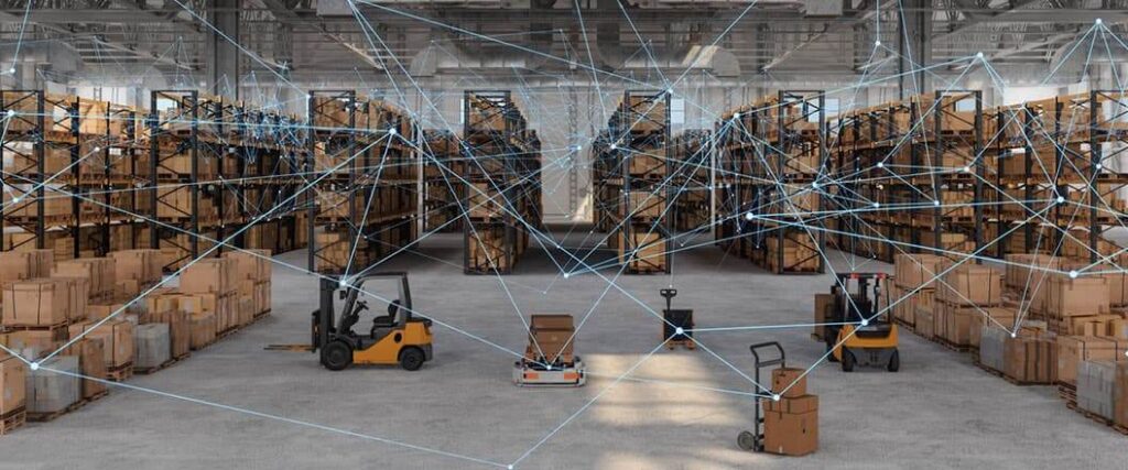A wide view of a warehouse floor with merchandise, forklifts, and pallet jacks connected by graphing lines.